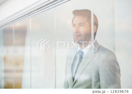 Portrait of thoughtful businessman through the window 12839676