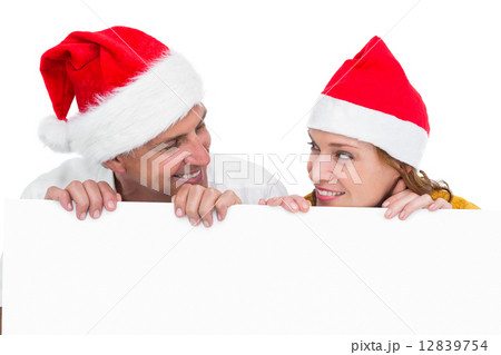 Festive couple showing a poster 12839754
