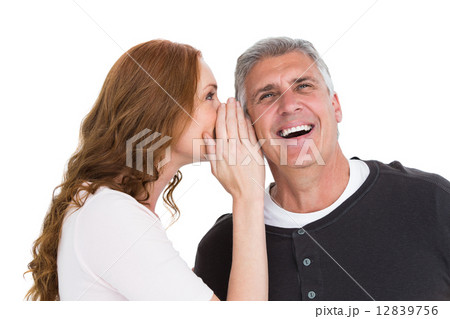 Woman telling secret to her partner Woman telling secret to her partner 12839756