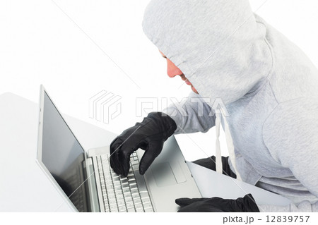 Hacker using laptop to steal identity Hacker using laptop to steal identity 12839757