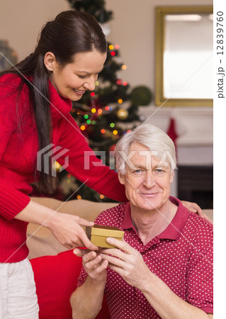 Happy mother offering gift to grandfather Happy mother offering gift to grandfather 12839760