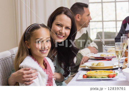 Girl and mother at christmas dinner smiling at camera Girl and mother at christmas dinner smiling at camera 12839761