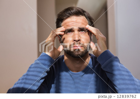 Depressed man sitting on floor 12839762