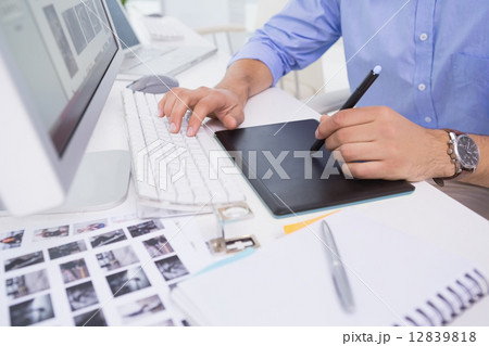 Graphic designer using digitizer at his desk 12839818