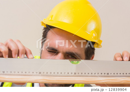 Construction worker using spirit level Construction worker using spirit level 12839904