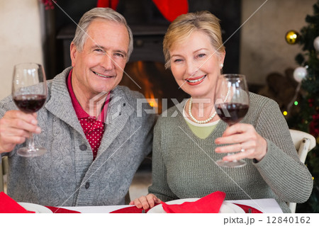 Couple toasting to the camera with red wine 12840162