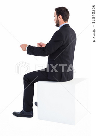 Businessman sitting and showing something with his hands 12840256