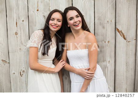 Pretty friends smiling in white dresses 12840257