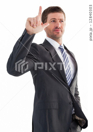 Serious businessman standing and pointing Serious businessman standing and pointing 12840303