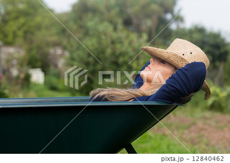 Pretty blonde napping in wheelbarrow Pretty blonde napping in wheelbarrow 12840462