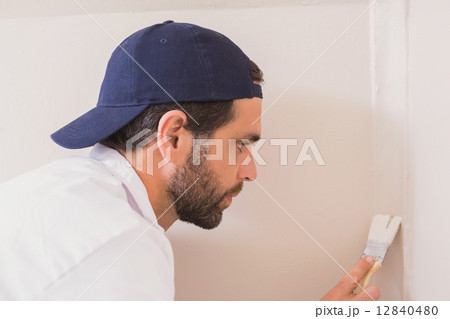 Painter painting the walls white Painter painting the walls white 12840480