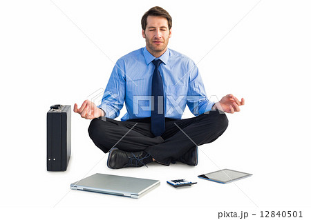 Man sitting in lotus pose with laptop, tablet and suitcase Man sitting in lotus pose with laptop, tablet and suitcase 12840501