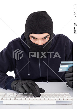 Concentrated burglar in balaclava shopping online Concentrated burglar in balaclava shopping online 12840625