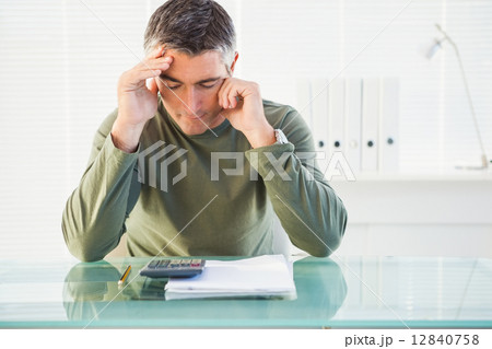 Concentrated man analyzing account 12840758