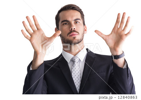 Serious businessman with finger spread out 12840863