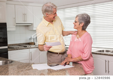 Senior couple paying their bills 12840986