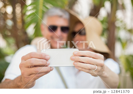 Holidaying couple taking a selfie Holidaying couple taking a selfie 12841370