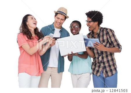 Stylish friends using their technology 12841503