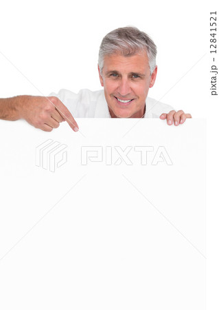Casual man showing a poster Casual man showing a poster 12841521
