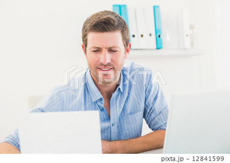 A businessman reading document 12841599