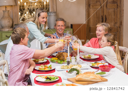 Three generation family enjoying christmas dinner together 12841742
