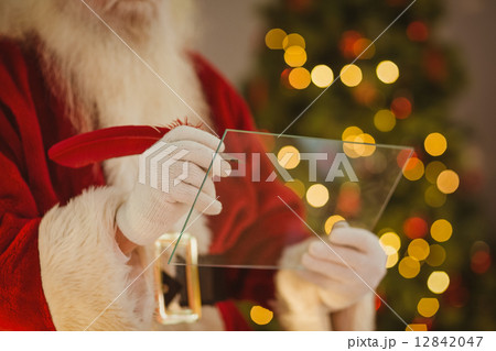Santa claus writing list on the glass Santa claus writing list on the glass 12842047