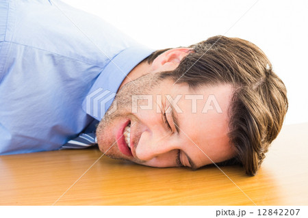 Casual businessman sleeping at his desk 12842207