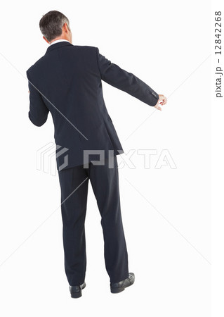 Businessman in suit standing and doing gesture Businessman in suit standing and doing gesture 12842268