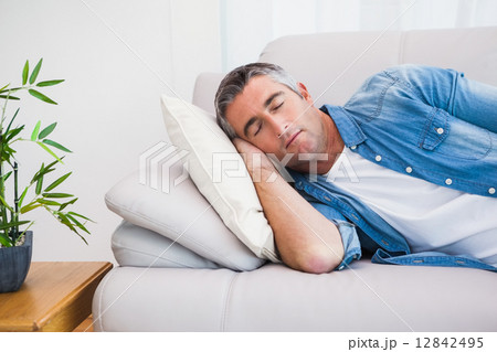 Man with grey hair sleeping on the couch Man with grey hair sleeping on the couch 12842495
