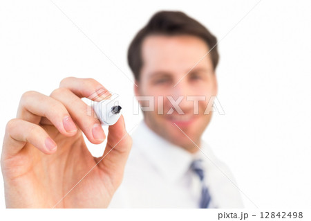 Smiling businessman writing with black marker Smiling businessman writing with black marker 12842498