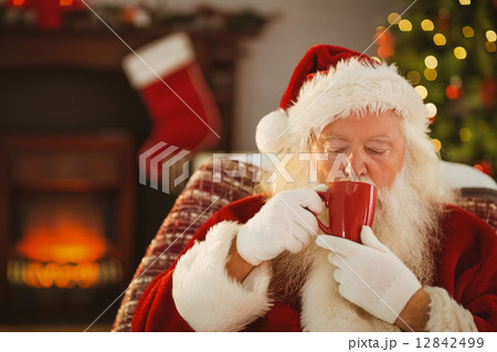 Father christmas drinking a hot beverage 12842499
