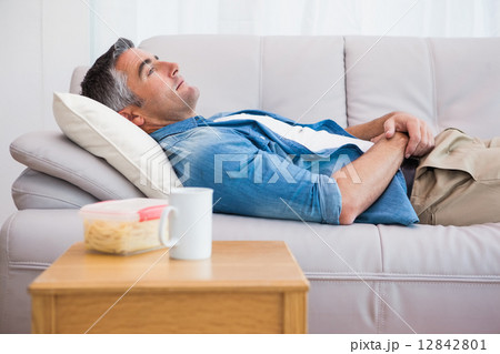 Relaxed man lying on the couch Relaxed man lying on the couch 12842801