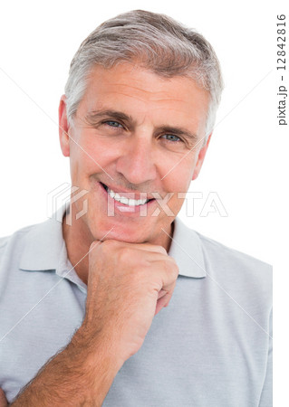 Casual man smiling with hand on chin Casual man smiling with hand on chin 12842816