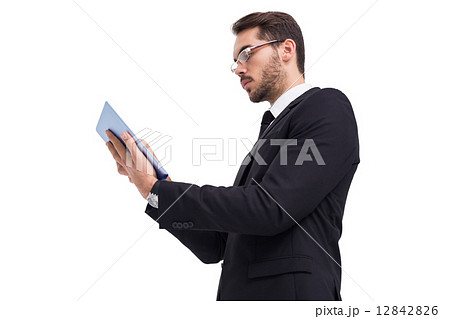 Businessman with glasses using his tablet Businessman with glasses using his tablet 12842826
