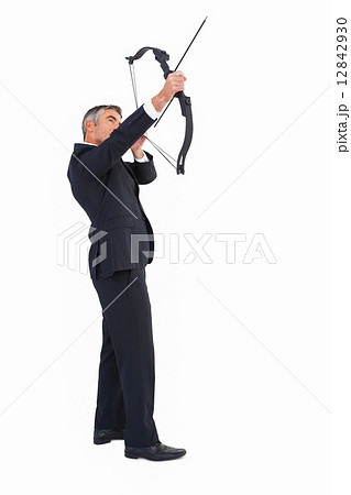 Elegant businessman stretching a bow Elegant businessman stretching a bow 12842930