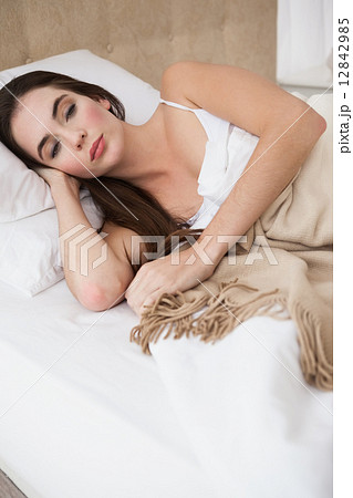 Pretty brunette lying in bed sleeping Pretty brunette lying in bed sleeping 12842985