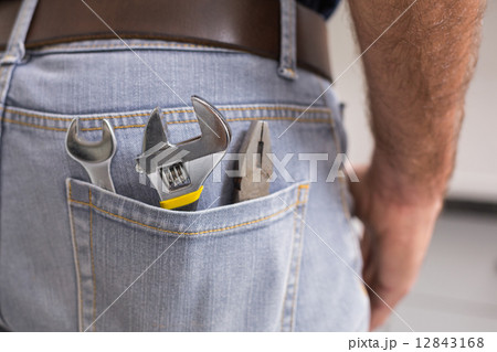Handyman with tools in back pocket 12843168