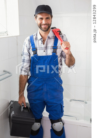 Plumber holding wrench and toolbox Plumber holding wrench and toolbox 12843299