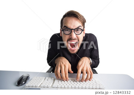 Excited businessman typing on keyboard 12843332