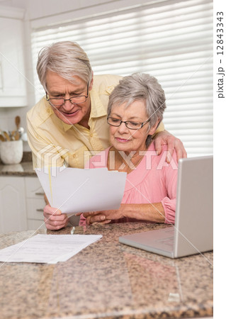 Senior couple paying their bills with laptop 12843343