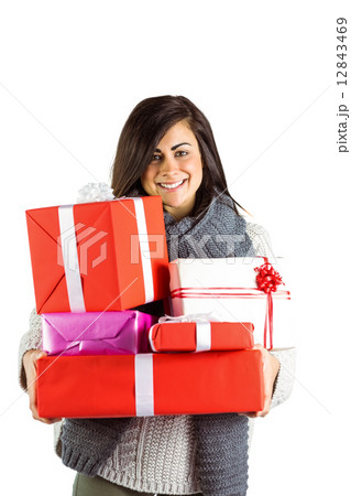 Smiling brunette holding many gifts Smiling brunette holding many gifts 12843469