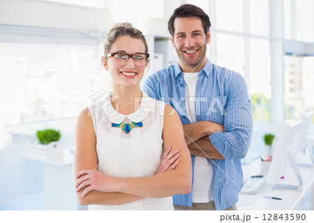Smilling photo editor posing with arms crossed Smilling photo editor posing with arms crossed 12843590
