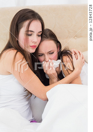 Brunette comforting her crying friend Brunette comforting her crying friend 12843728