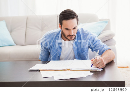 Focused man paying his bills 12843999