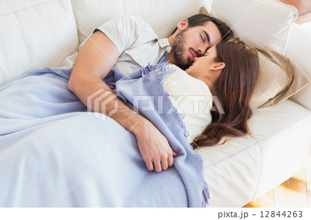 Cute couple napping on couch Cute couple napping on couch 12844263