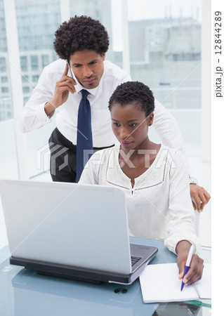 Team on the phone and taking notes 12844289