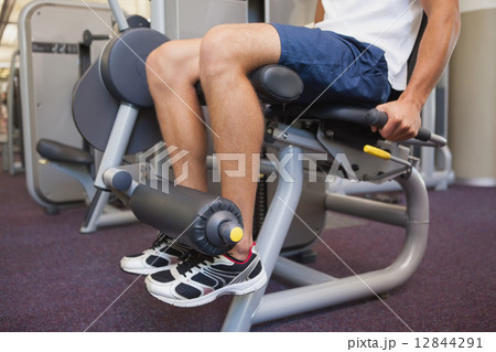 Fit man using weights machine for legs Fit man using weights machine for legs 12844291