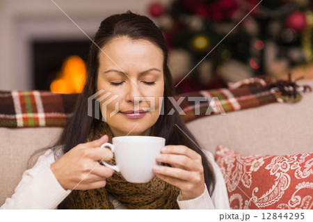Pretty brunette enjoying hot chocolate Pretty brunette enjoying hot chocolate 12844295
