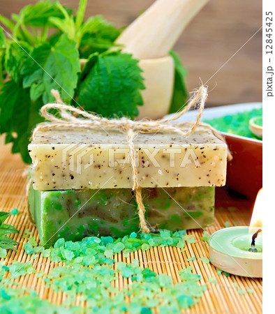Soap homemade and candle with nettles in mortar on board 12845425