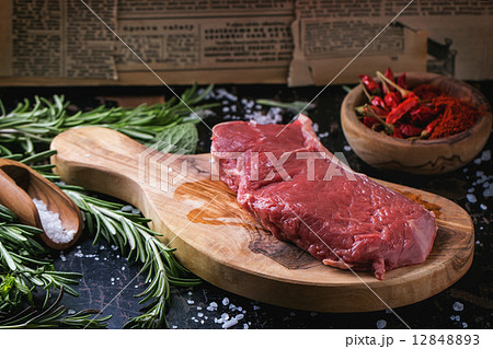 Raw steak with herbs and pepper Raw steak with herbs and pepper 12848893